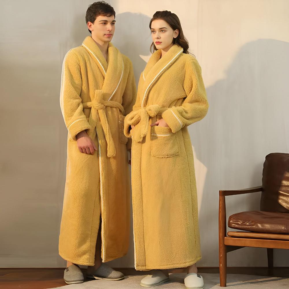 Couple wearing matching long yellow fleece bathrobes with shawl collars, front pockets, and waist belts, cozy winter loungewear