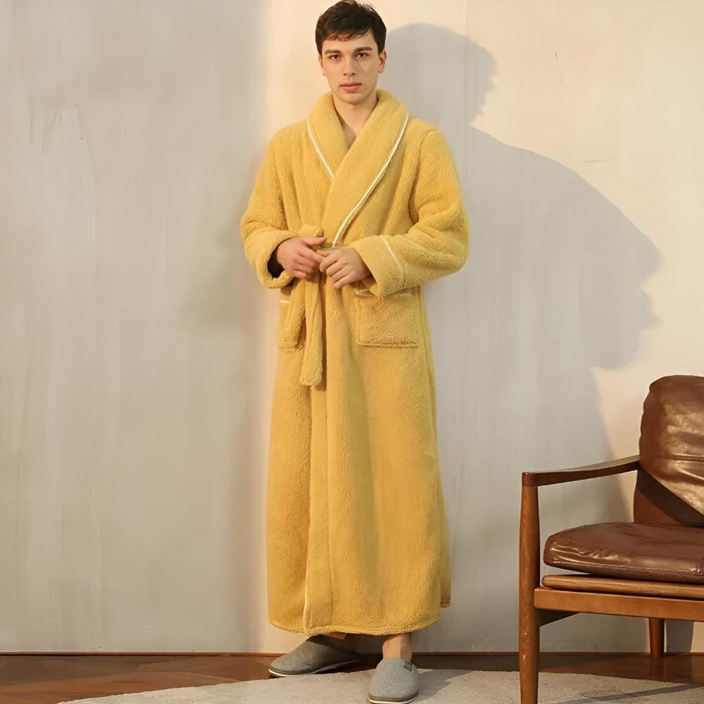 Couple wearing matching long yellow fleece bathrobes with shawl collars, front pockets, and waist belts, cozy winter loungewear