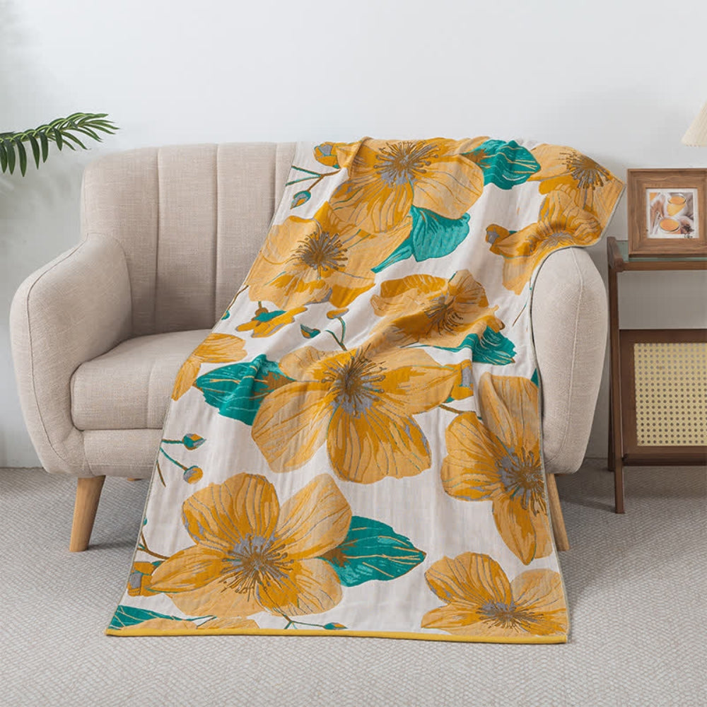 Floral throw blanket with yellow flower and green leaf design on white background, soft decorative sofa and bed cover