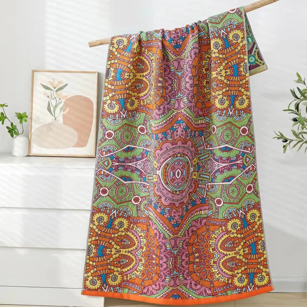 Colorful bohemian mandala throw blanket with intricate geometric and floral patterns in orange, green, pink, and yellow