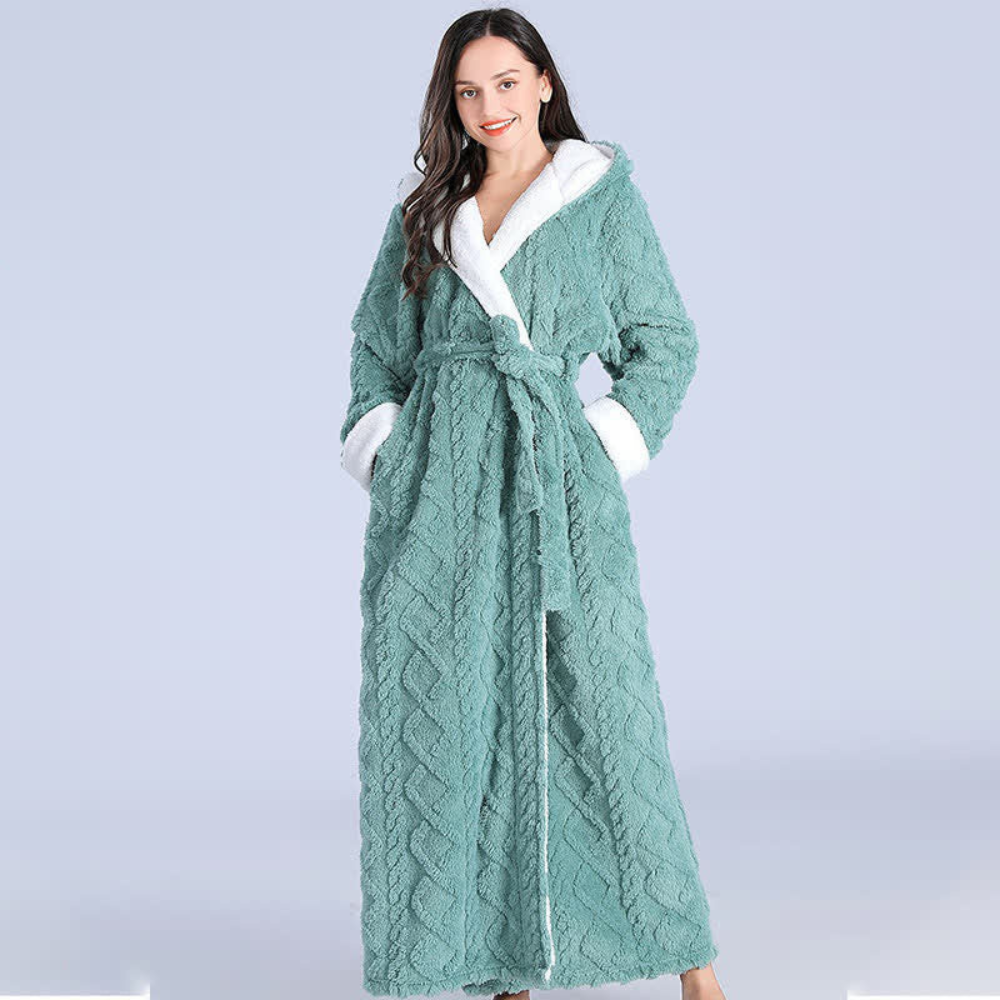 Women's long purple fleece bathrobe with hood, white trim, and textured chevron pattern, cozy winter loungewear