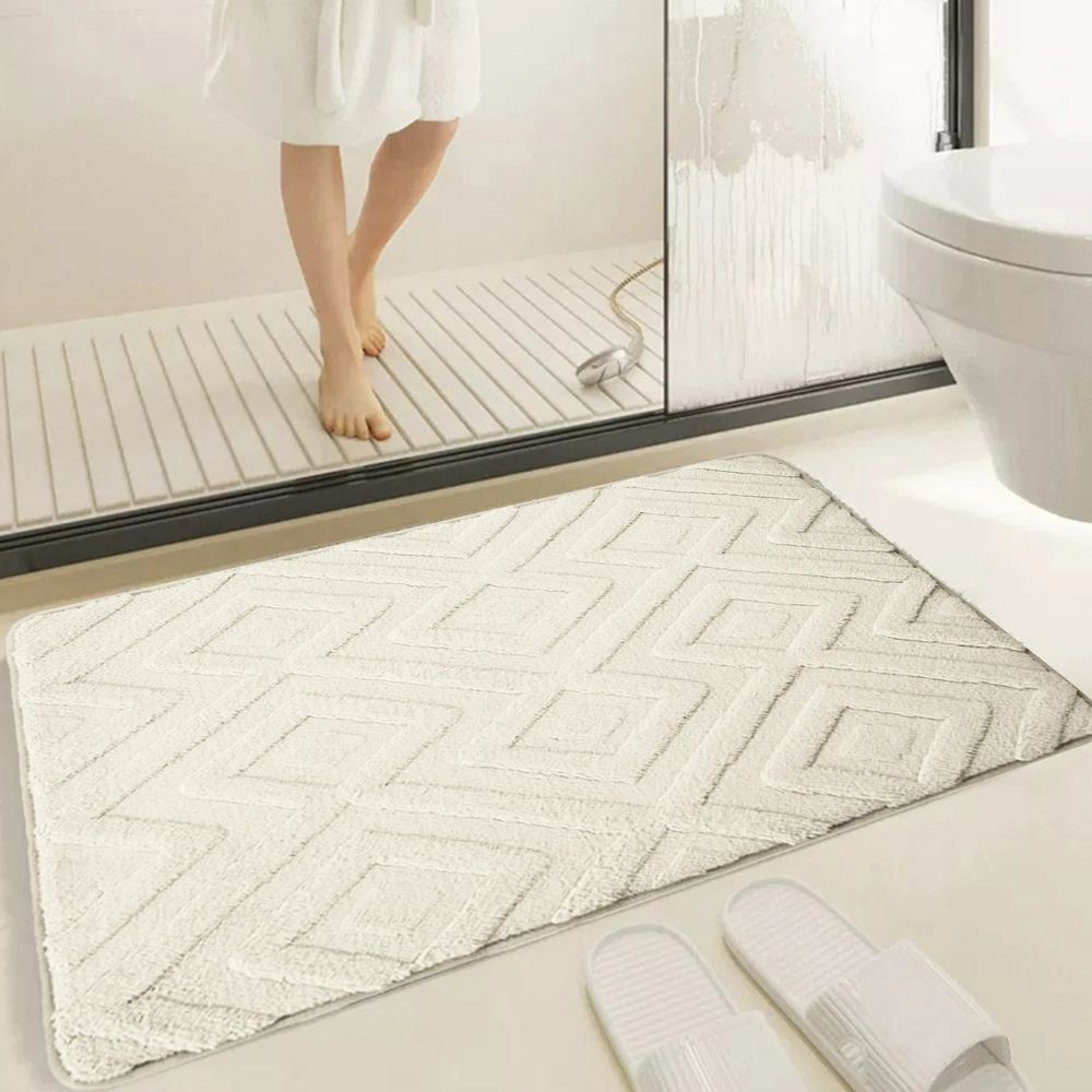 White geometric bath mat with diamond pattern, absorbent and non-slip plush rug for bathroom, shower, or tub