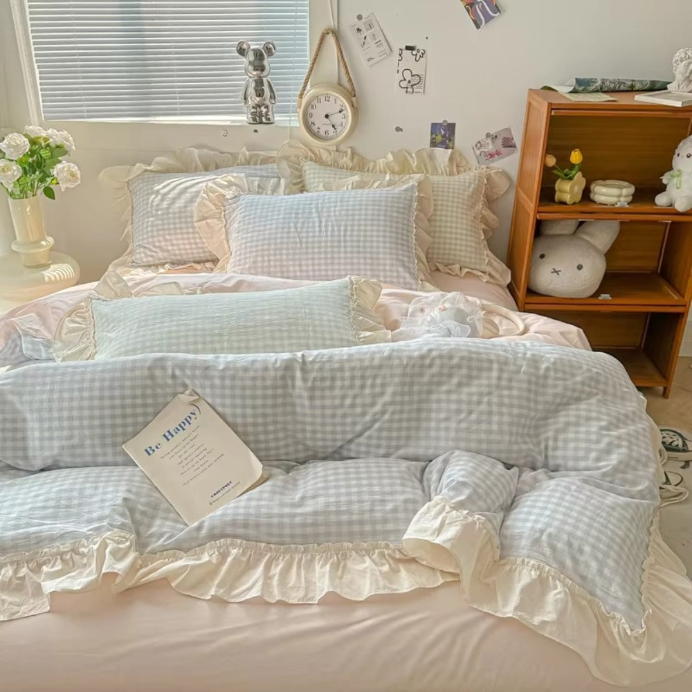 Pastel pink gingham ruffle bedding set with cream frilled edges, soft cotton duvet cover and pillowcases in romantic shabby chic bedroom decor