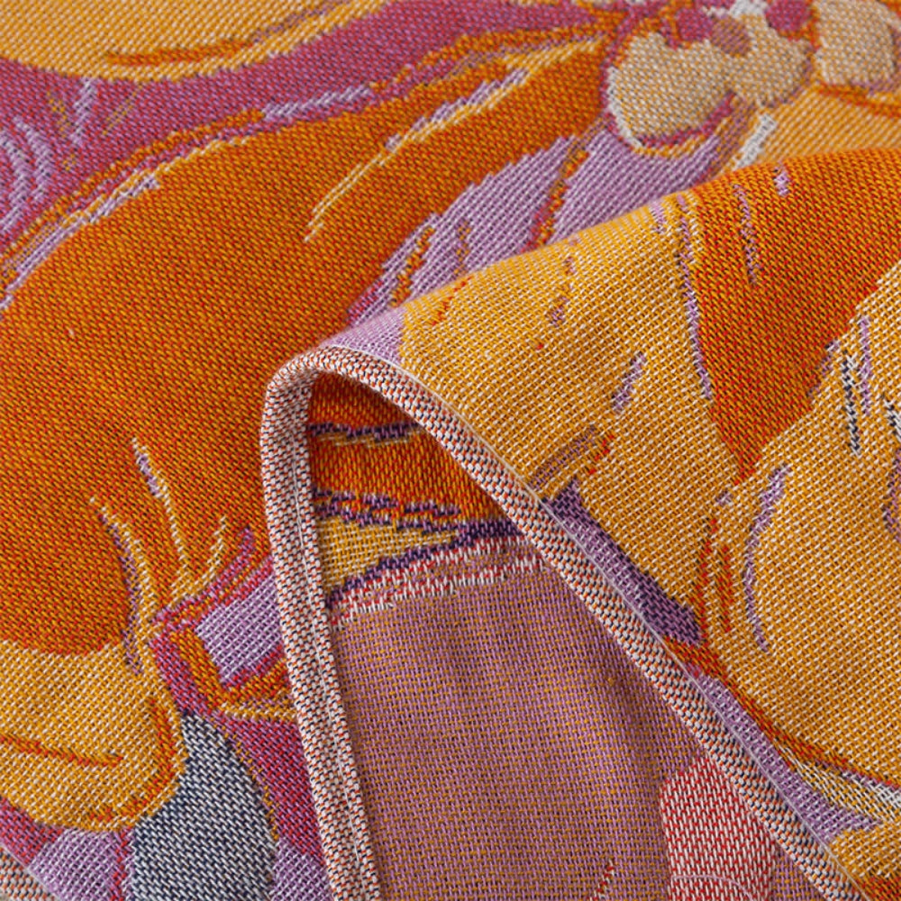 Floral throw blanket with orange and yellow flower pattern on purple background, soft decorative sofa and bed cover