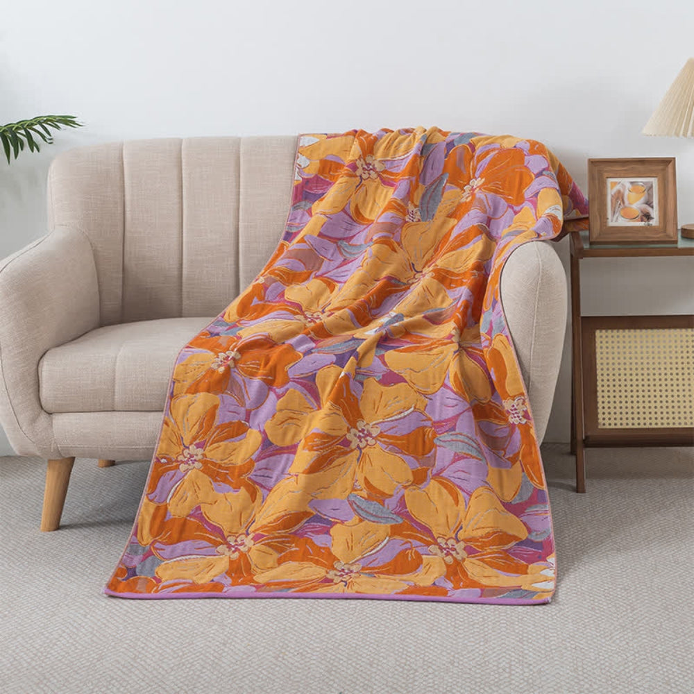 Floral throw blanket with orange and yellow flower pattern on purple background, soft decorative sofa and bed cover