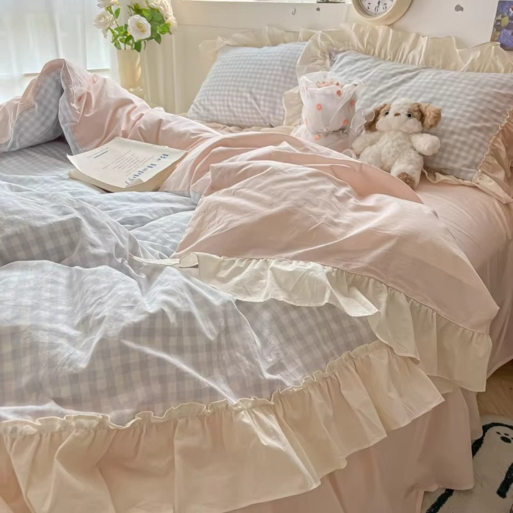 Pastel pink gingham ruffle bedding set with cream frilled edges, soft cotton duvet cover and pillowcases in romantic shabby chic bedroom decor