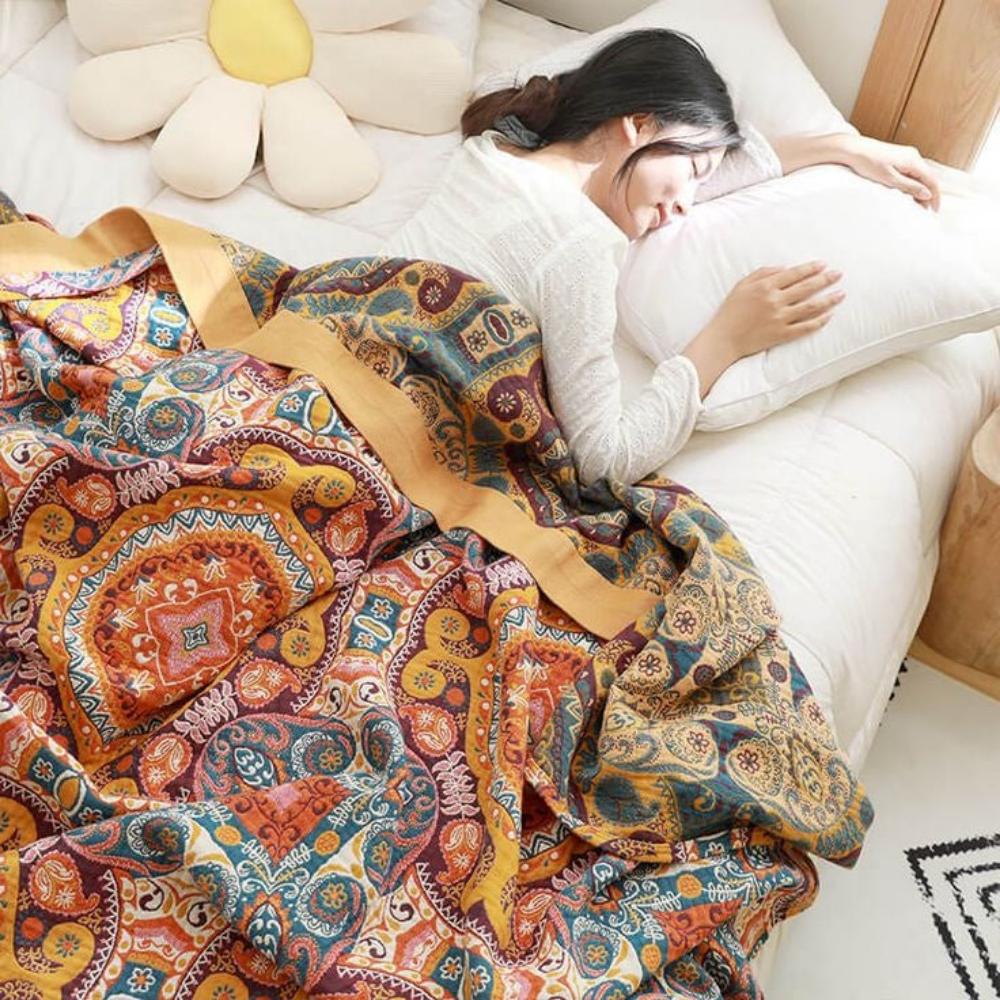 Bohemian patchwork quilt blanket with vibrant mandala and paisley patterns in orange, red, and blue – lightweight bedspread or throw