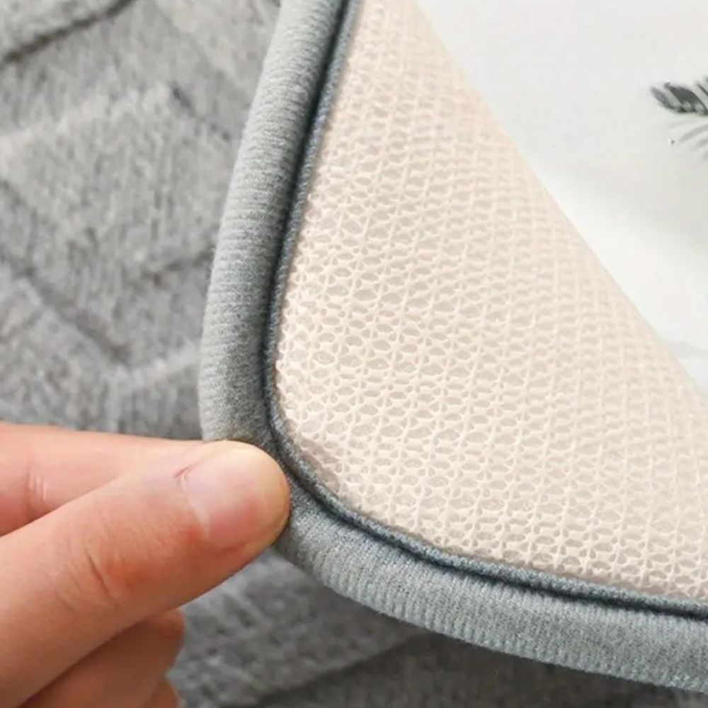 White geometric bath mat with diamond pattern, absorbent and non-slip plush rug for bathroom, shower, or tub