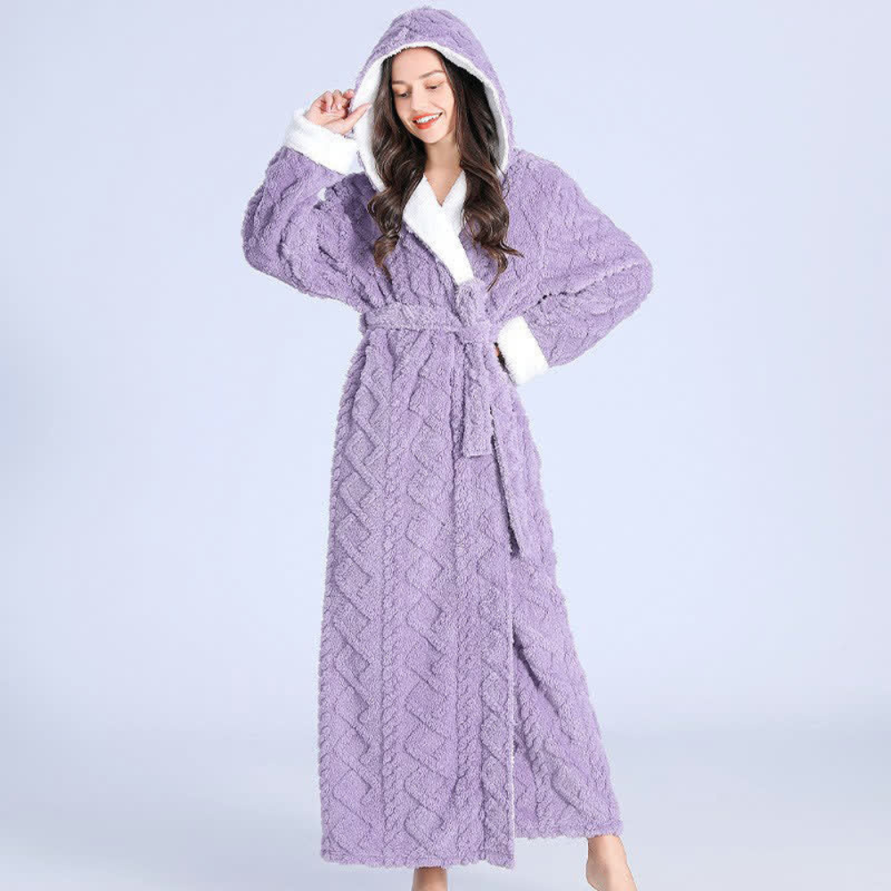 Women's long purple fleece bathrobe with hood, white trim, and textured chevron pattern, cozy winter loungewear