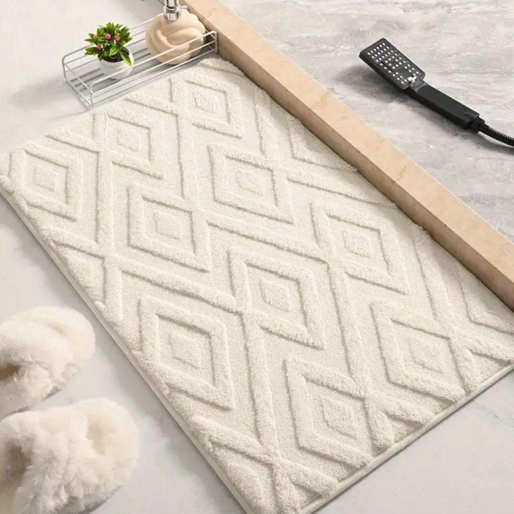 White geometric bath mat with diamond pattern, absorbent and non-slip plush rug for bathroom, shower, or tub