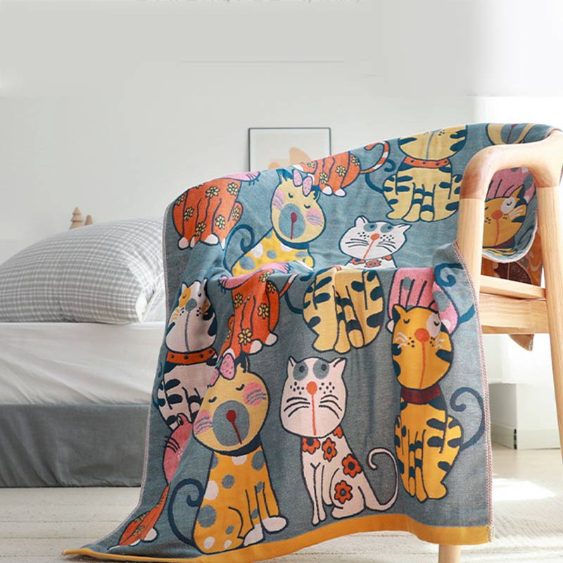 Colorful kids blanket with cartoon cat design in orange, yellow, and blue, soft cotton throw for bedroom or nursery