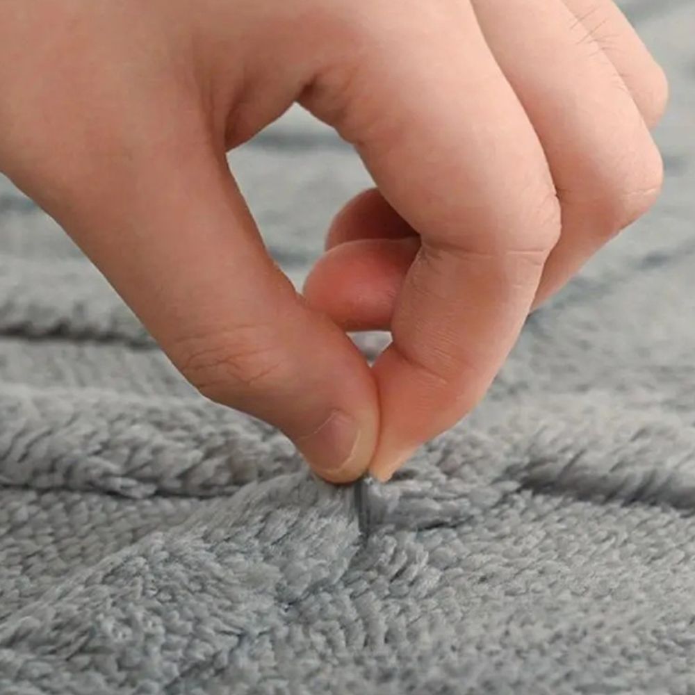 White geometric bath mat with diamond pattern, absorbent and non-slip plush rug for bathroom, shower, or tub