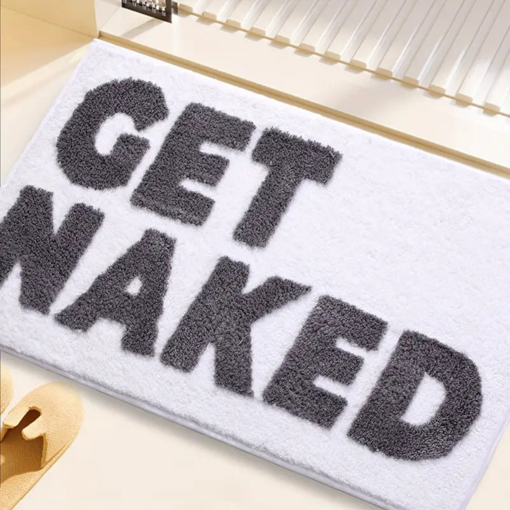 Pink bath mat with bold red ‘Get Naked’ lettering, soft absorbent funny bathroom rug for modern decor