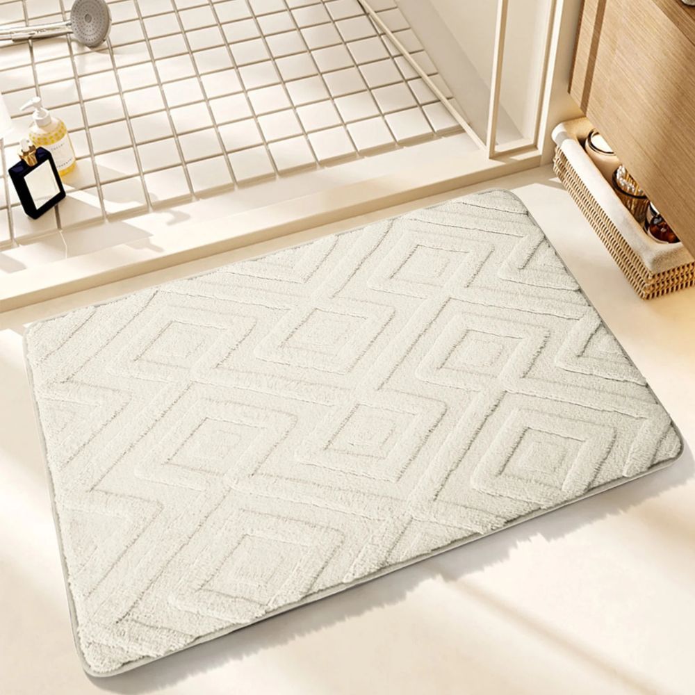 White geometric bath mat with diamond pattern, absorbent and non-slip plush rug for bathroom, shower, or tub
