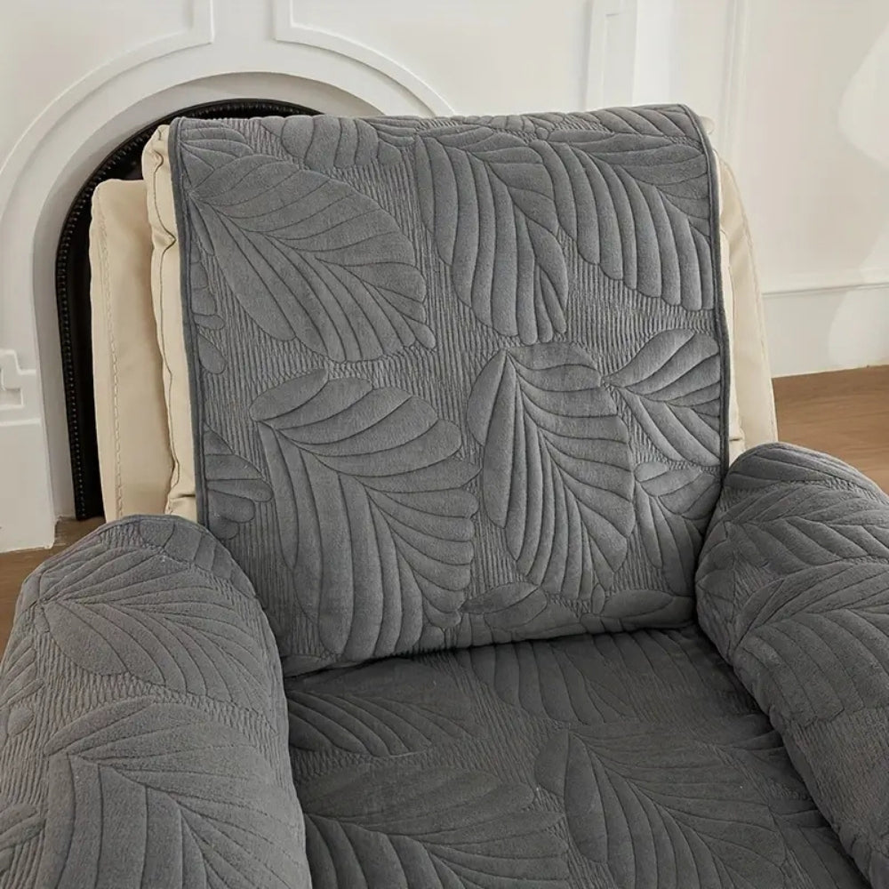 Grey quilted recliner chair cover with leaf pattern, soft padded armrest protectors and side storage pocket for living room furniture protection
