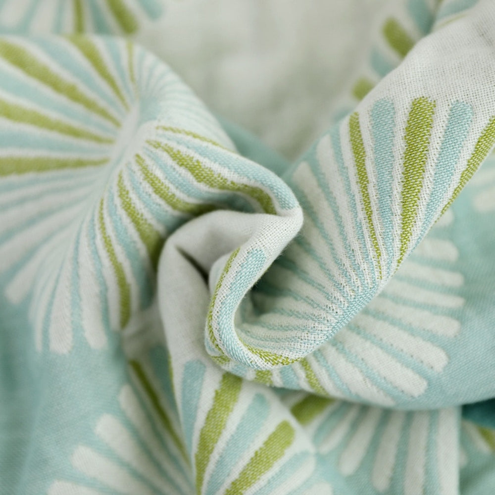 Light green and white throw blanket with modern fan circle pattern, soft decorative accent for sofa or bed