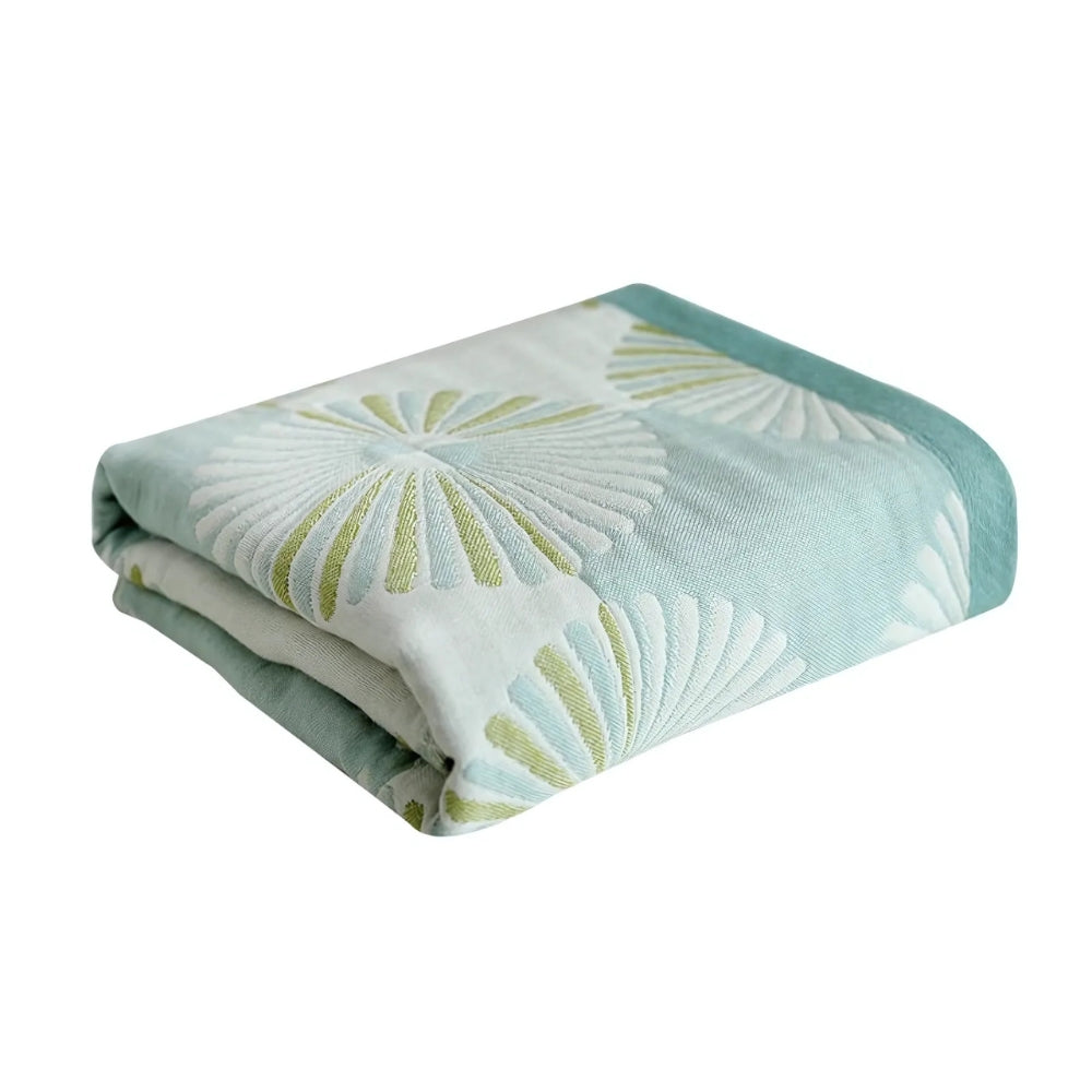 Light green and white throw blanket with modern fan circle pattern, soft decorative accent for sofa or bed