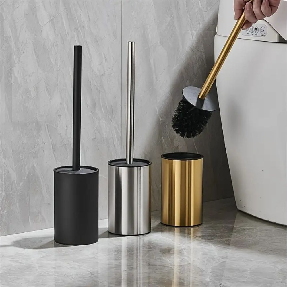 Gold toilet brush with black bristles and matching holder, modern stainless steel bathroom cleaning set