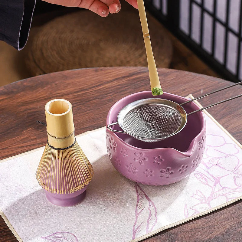 Japanese matcha tea whisk with purple cherry blossom bowl, traditional bamboo chasen for green tea ceremony