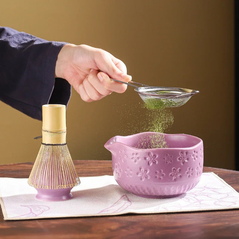 Japanese matcha tea whisk with purple cherry blossom bowl, traditional bamboo chasen for green tea ceremony