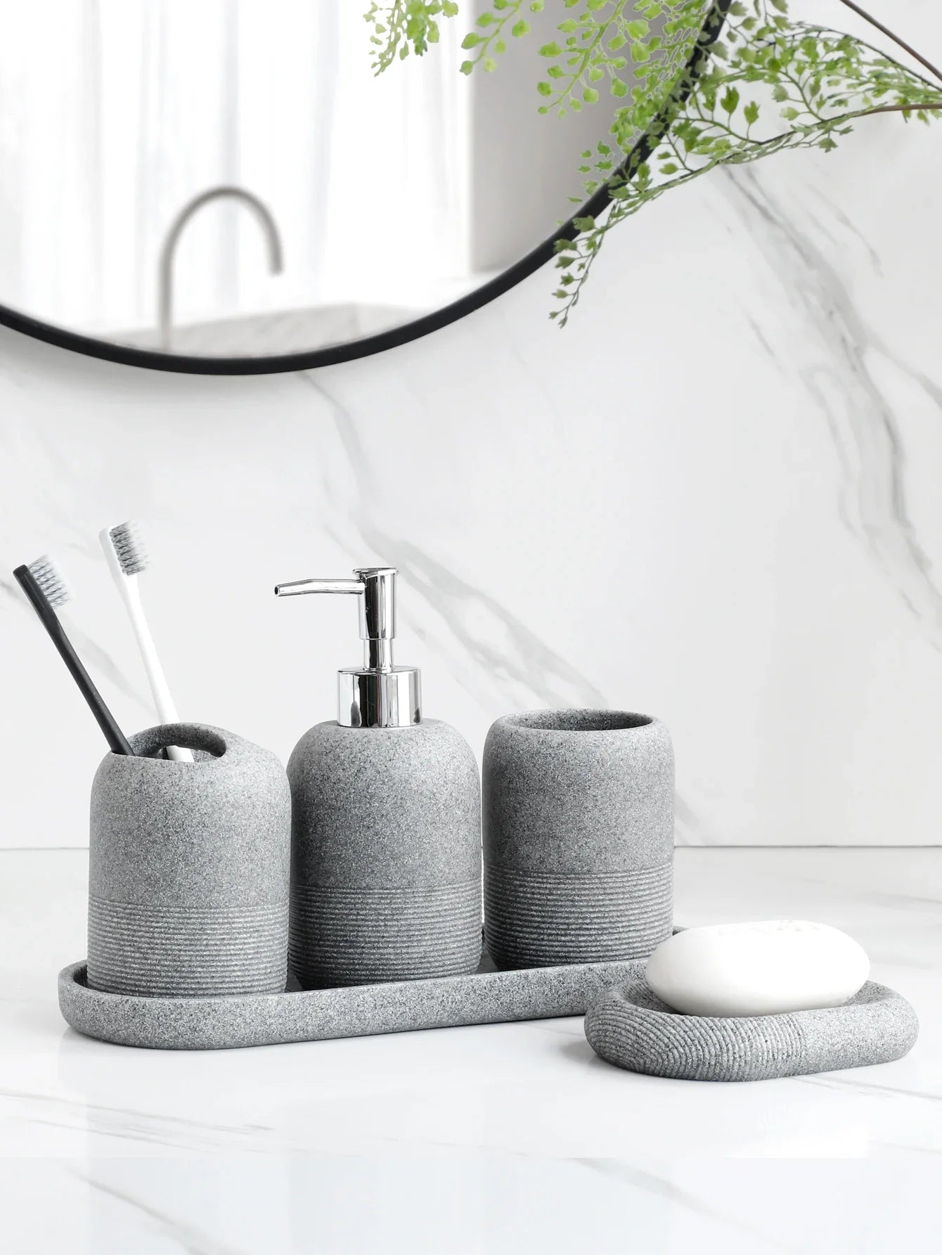 Minimalist ceramic bathroom accessory set with soap dispenser, toothbrush holder, and soap dish for modern home decor