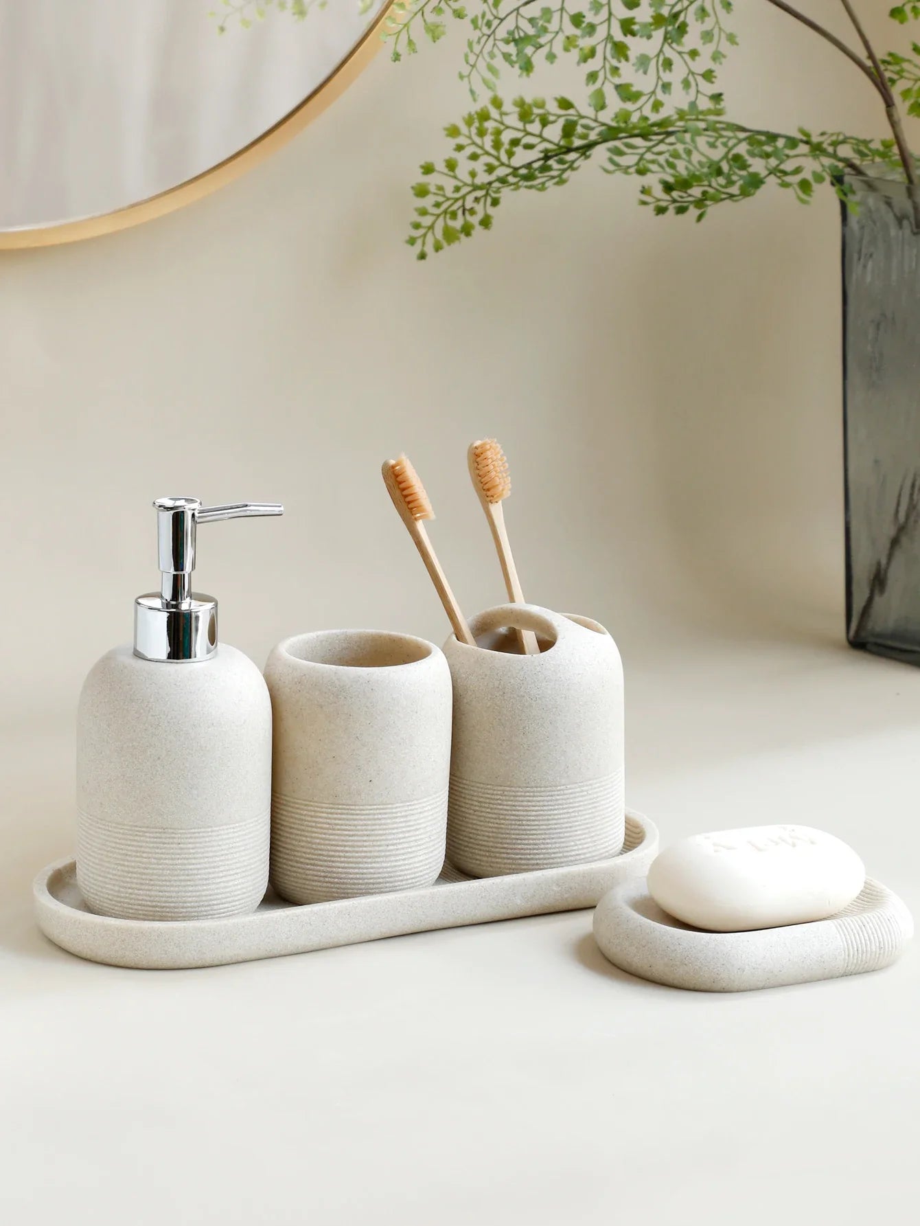 Minimalist ceramic bathroom accessory set with soap dispenser, toothbrush holder, and soap dish for modern home decor