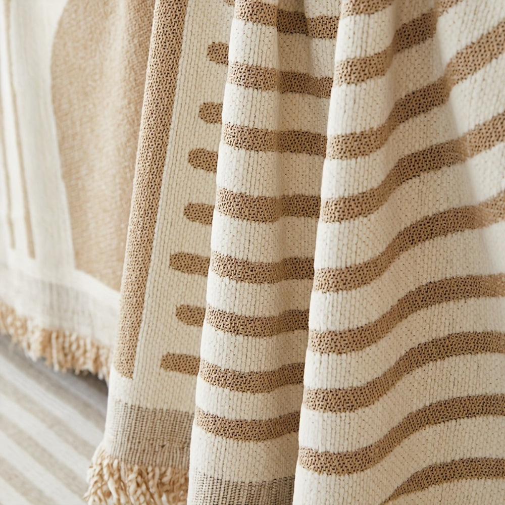 Modern geometric grey and white sofa cover with abstract wave pattern and fringe edges – washable couch slipcover for living room furniture protection