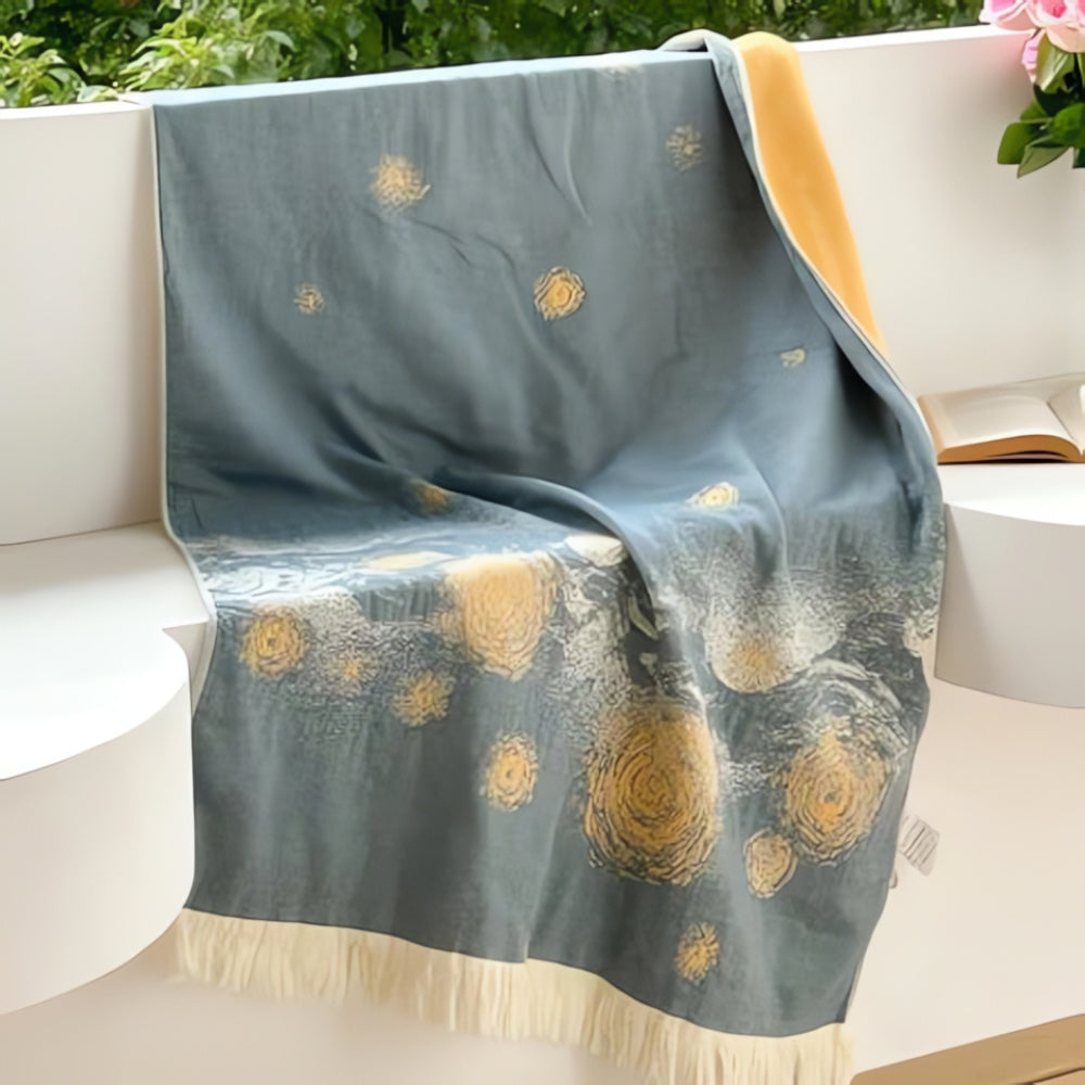 Soft throw blanket with Van Gogh inspired starry night design in blue and yellow, with fringe edges