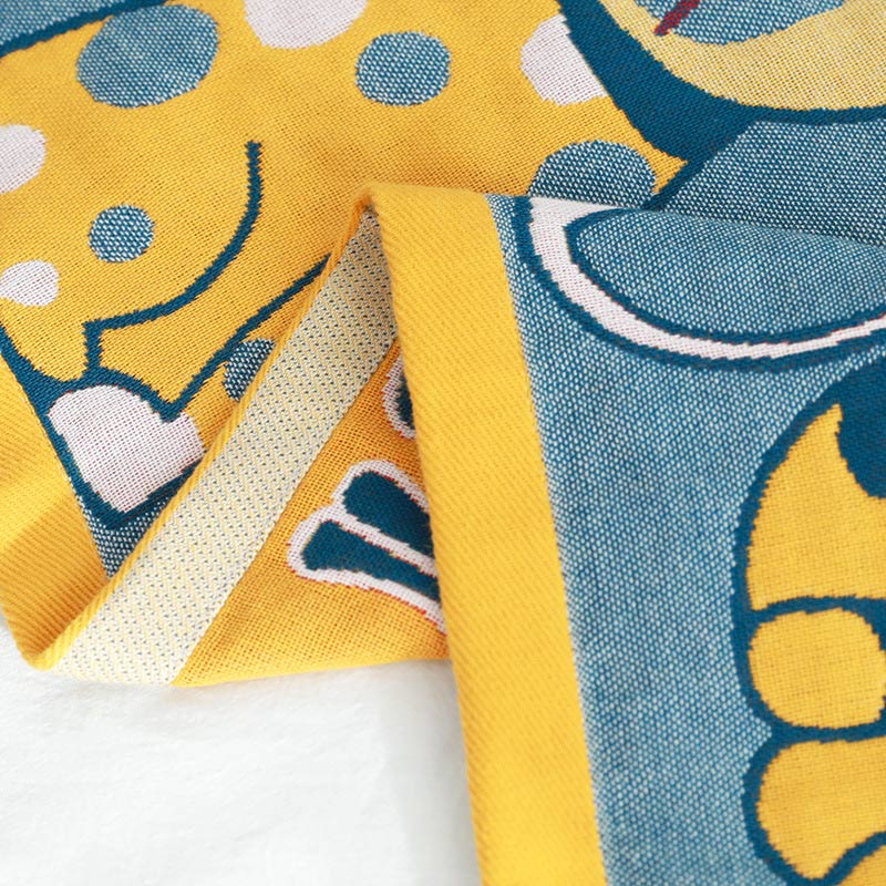 Colorful kids blanket with cartoon cat design in orange, yellow, and blue, soft cotton throw for bedroom or nursery