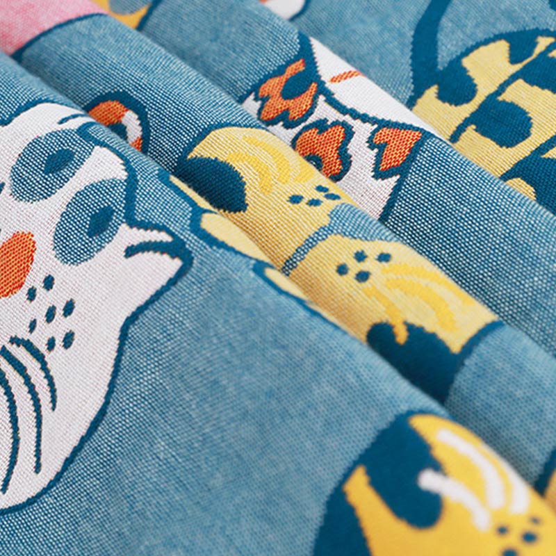 Colorful kids blanket with cartoon cat design in orange, yellow, and blue, soft cotton throw for bedroom or nursery
