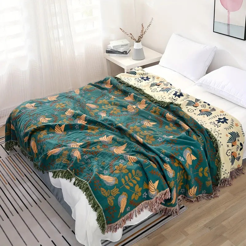 Bohemian sofa throw blanket with teal background, bird and floral patterns, and fringe edges, decorative couch cover for living room
