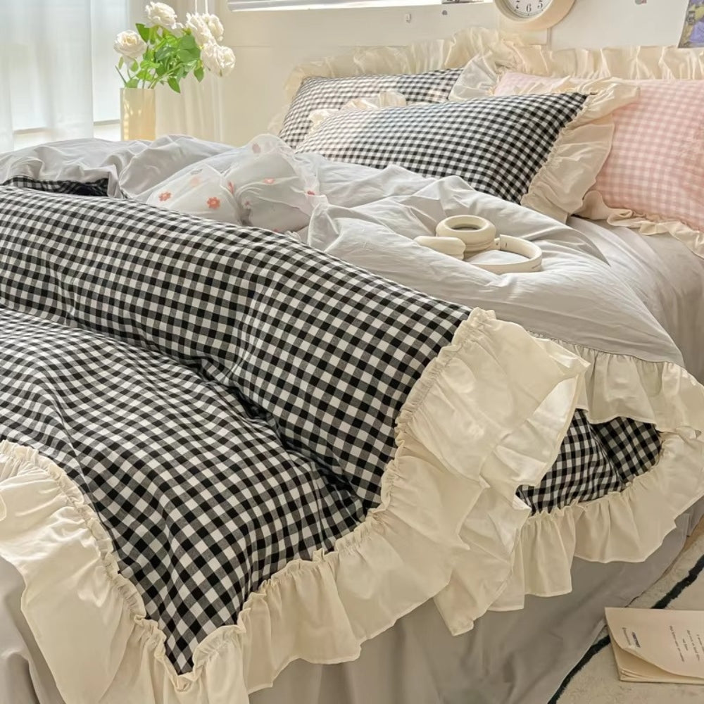 Pastel pink gingham ruffle bedding set with cream frilled edges, soft cotton duvet cover and pillowcases in romantic shabby chic bedroom decor