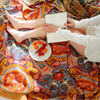 Bohemian patchwork quilt blanket with vibrant mandala and paisley patterns in orange, red, and blue – lightweight bedspread or throw