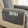 Grey quilted recliner chair cover with leaf pattern, soft padded armrest protectors and side storage pocket for living room furniture protection