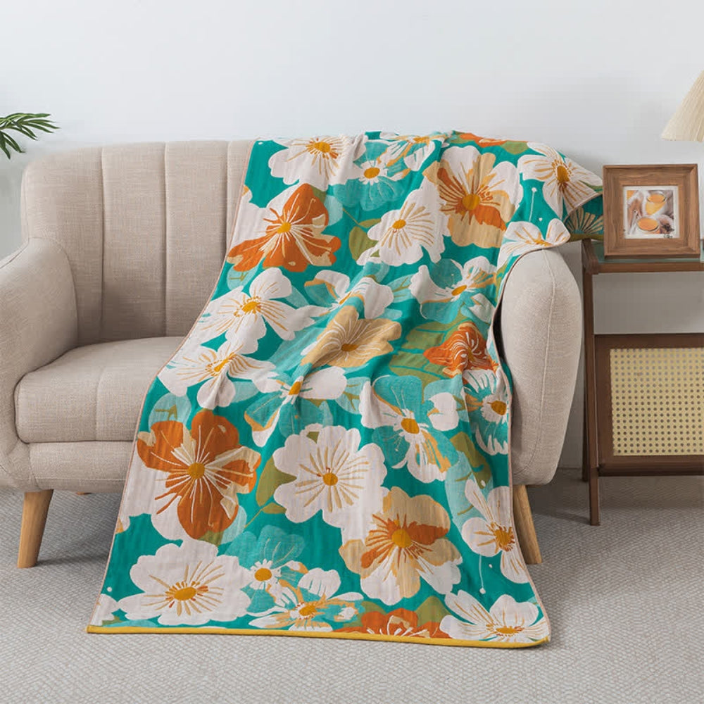 Floral throw blanket with white and orange flower design on teal background, soft decorative sofa and bed cover