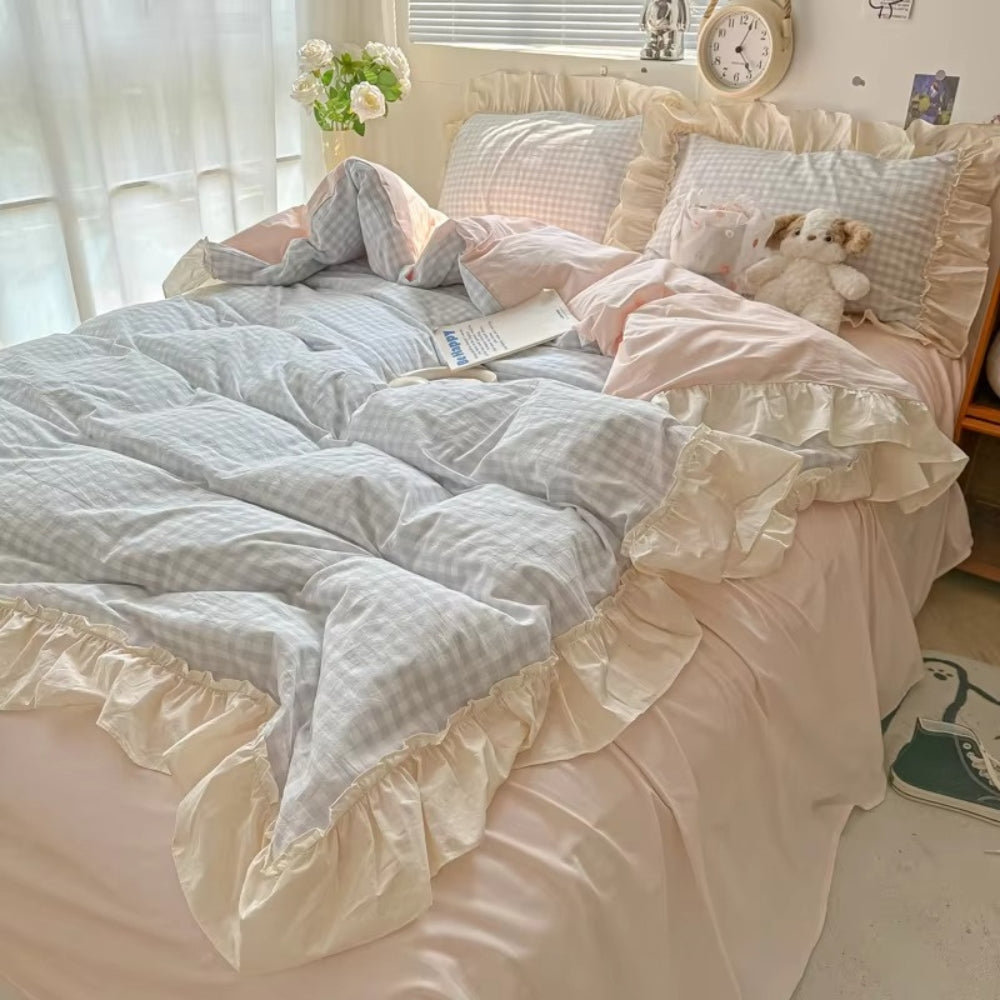 Pastel pink gingham ruffle bedding set with cream frilled edges, soft cotton duvet cover and pillowcases in romantic shabby chic bedroom decor