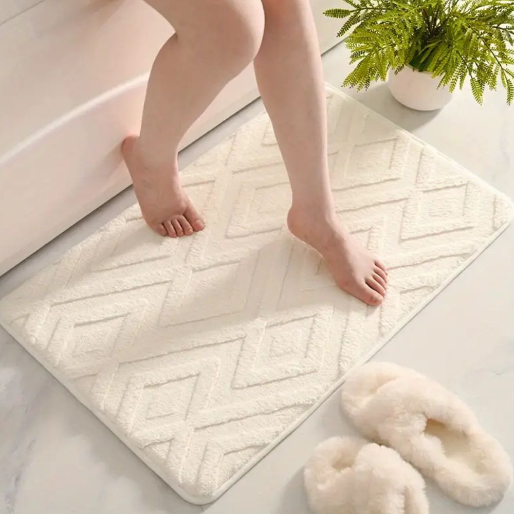 White geometric bath mat with diamond pattern, absorbent and non-slip plush rug for bathroom, shower, or tub
