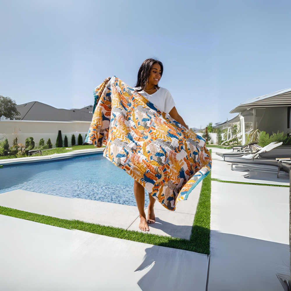 Reversible beach towel with tropical floral pattern in vibrant blue, orange, and green, quick-dry cotton for pool or seaside