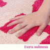 Pink bath mat with bold red ‘Get Naked’ lettering, soft absorbent funny bathroom rug for modern decor