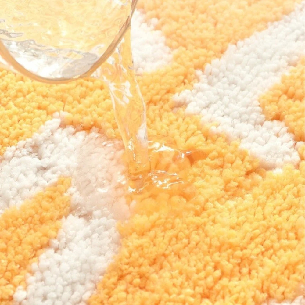 Yellow lemon-shaped bathroom rug with white text ‘Squeeze the Day’, soft absorbent bath mat