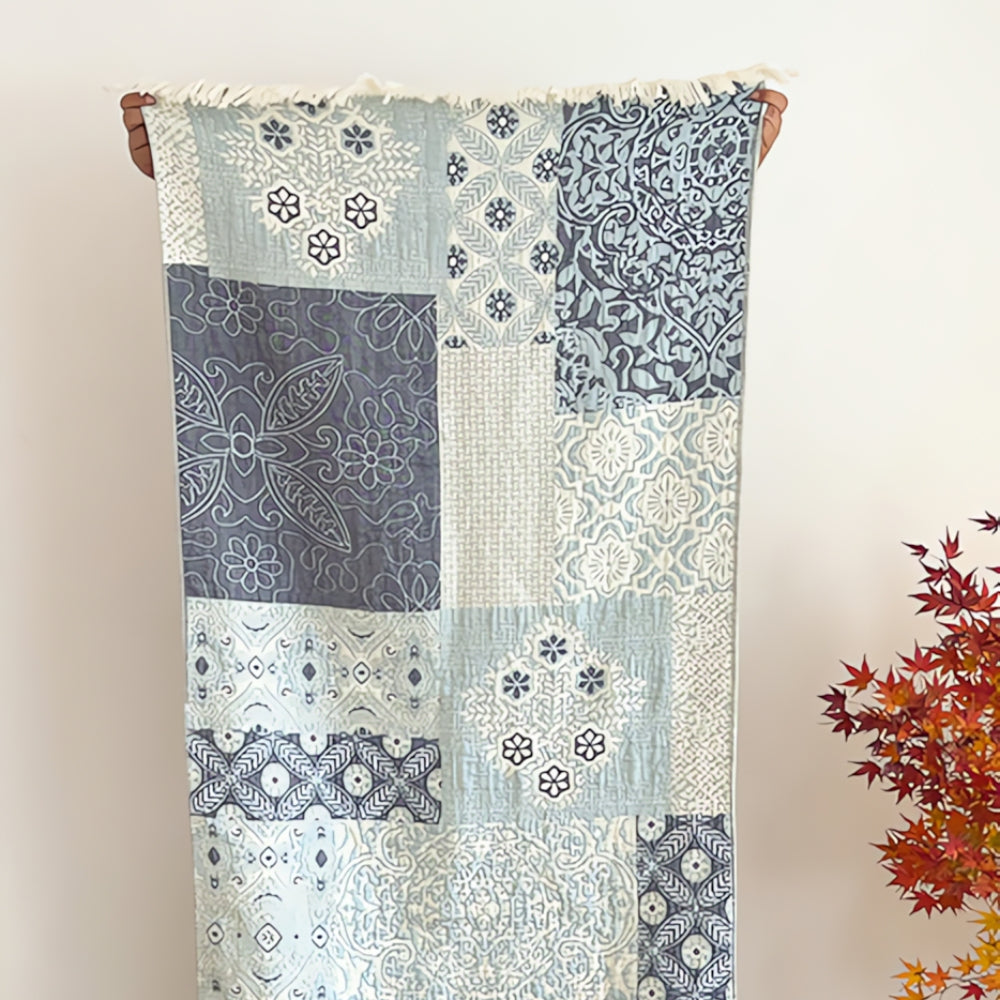 Soft throw blanket with Van Gogh inspired starry night design in blue and yellow, with fringe edges