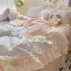 Pastel pink gingham ruffle bedding set with cream frilled edges, soft cotton duvet cover and pillowcases in romantic shabby chic bedroom decor