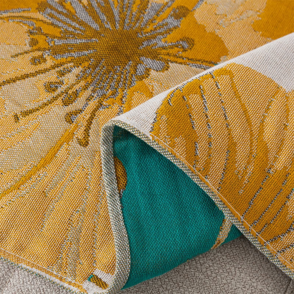 Floral throw blanket with yellow flower and green leaf design on white background, soft decorative sofa and bed cover