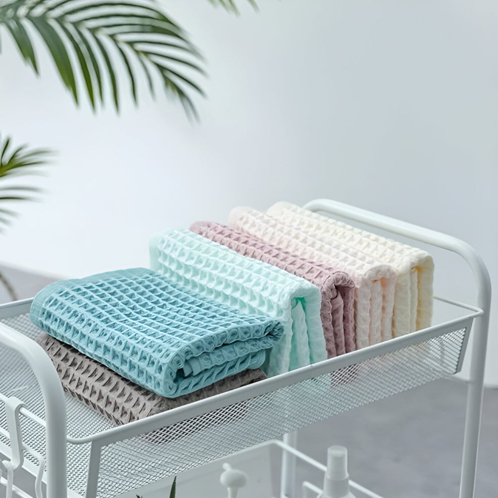 Waffle weave bath towel in pastel colors including pink, blue, white, and gray, ultra-absorbent and quick-drying