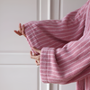Soft pink terry bathrobe with white stripes and wide sleeves, cozy absorbent loungewear