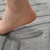 White geometric bath mat with diamond pattern, absorbent and non-slip plush rug for bathroom, shower, or tub