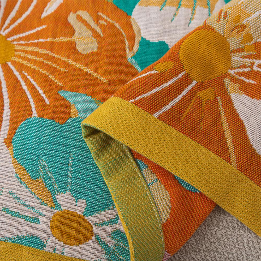 Floral throw blanket with white and orange flower design on teal background, lightweight decorative sofa and bed cover