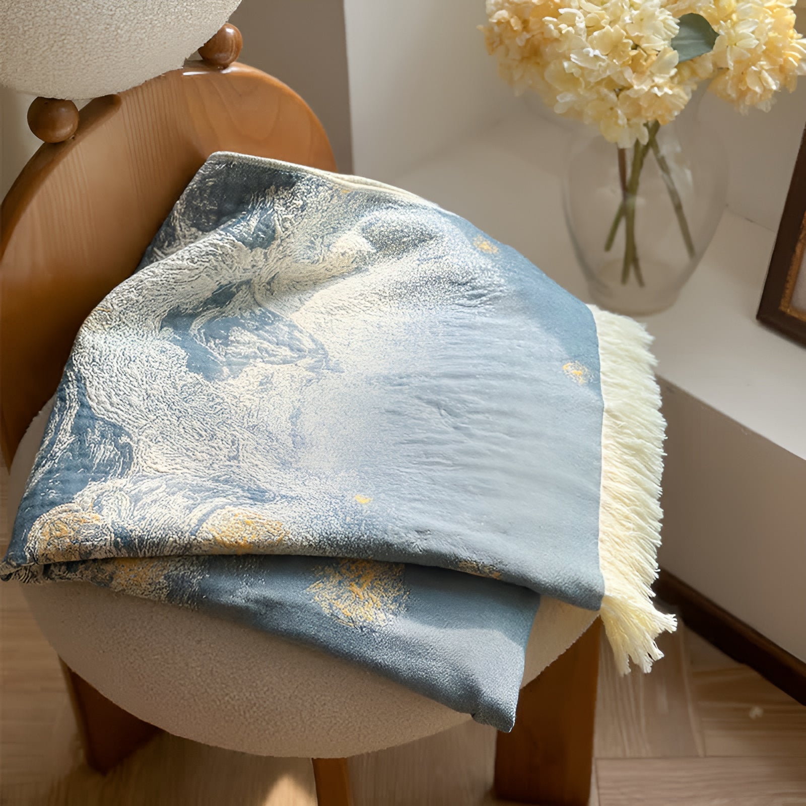 Soft throw blanket with Van Gogh inspired starry night design in blue and yellow, with fringe edges