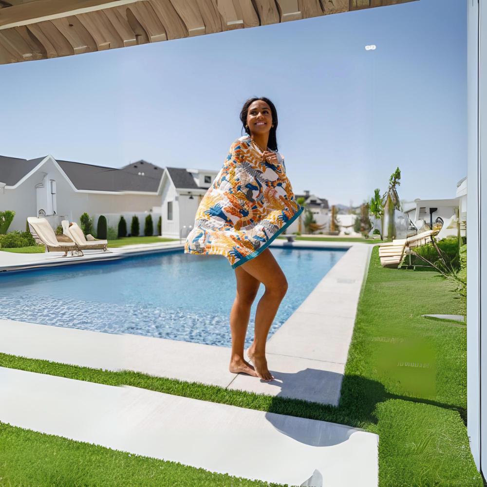 Reversible beach towel with tropical floral pattern in vibrant blue, orange, and green, quick-dry cotton for pool or seaside