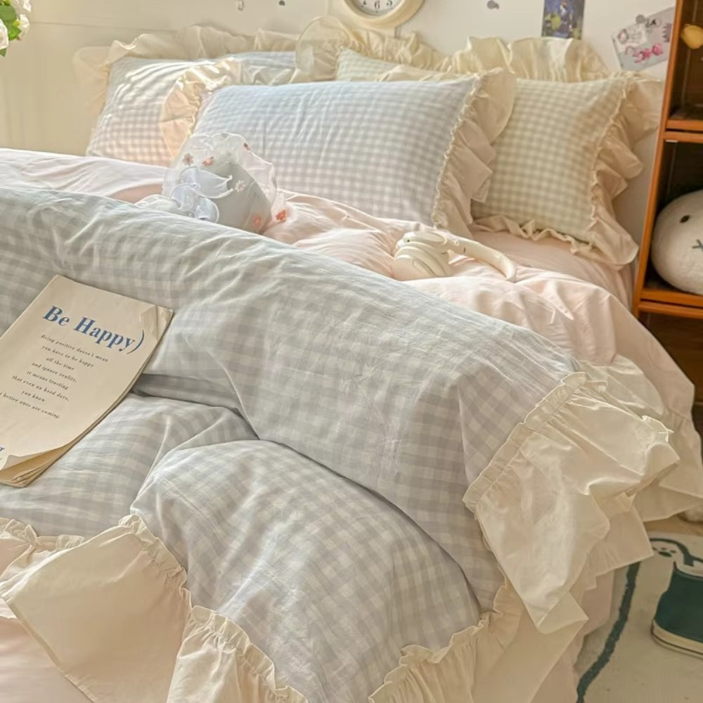 Pastel pink gingham ruffle bedding set with cream frilled edges, soft cotton duvet cover and pillowcases in romantic shabby chic bedroom decor